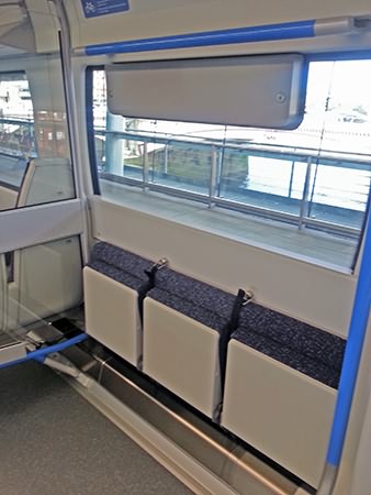 The fold down seating adjacent to the wheelchair accessible lavatory and wheelchair area.
