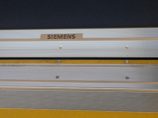 Metal rubbing strips and Siemens branding at the bottom of the plug doors.